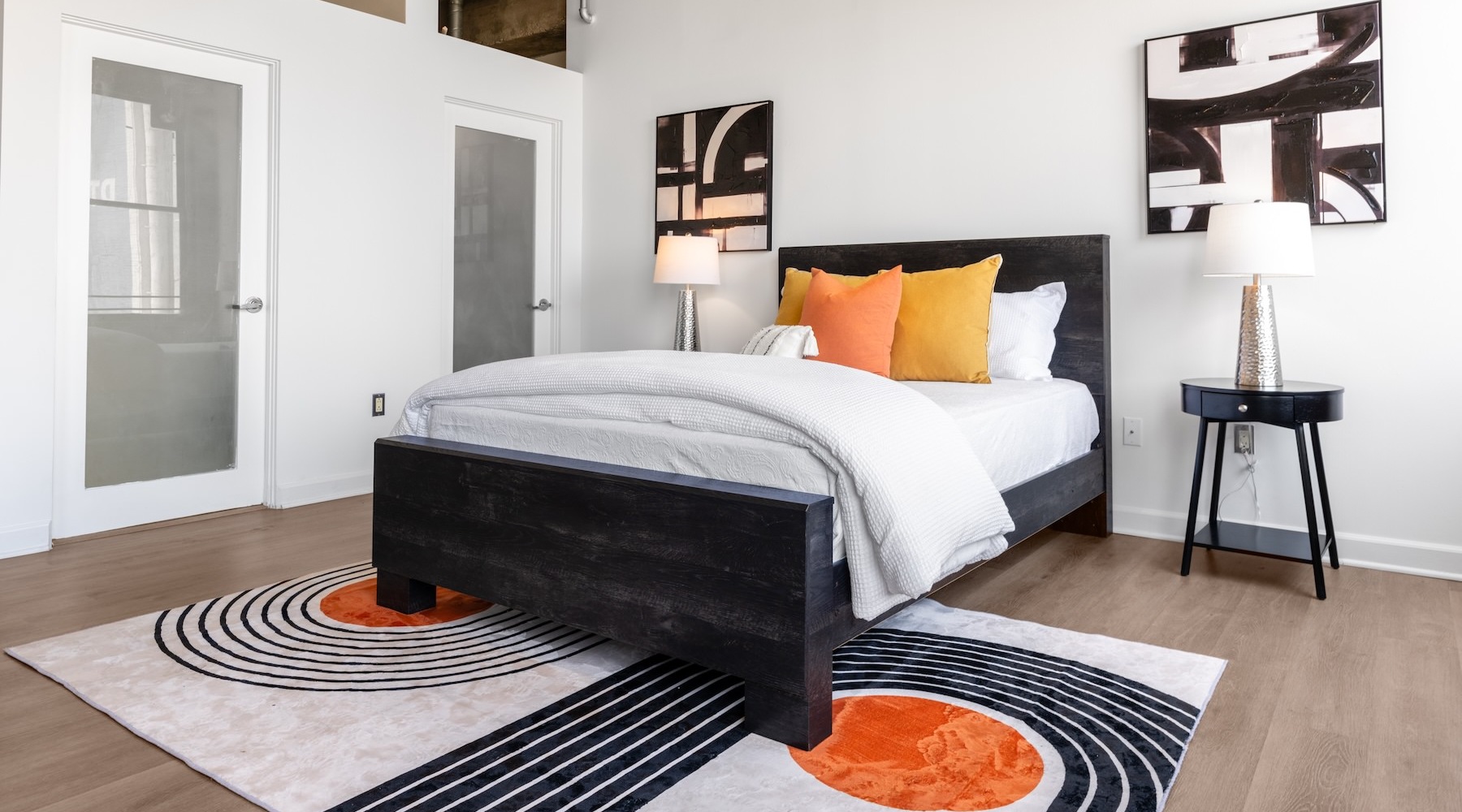 a bedroom with a bed and two nightstands