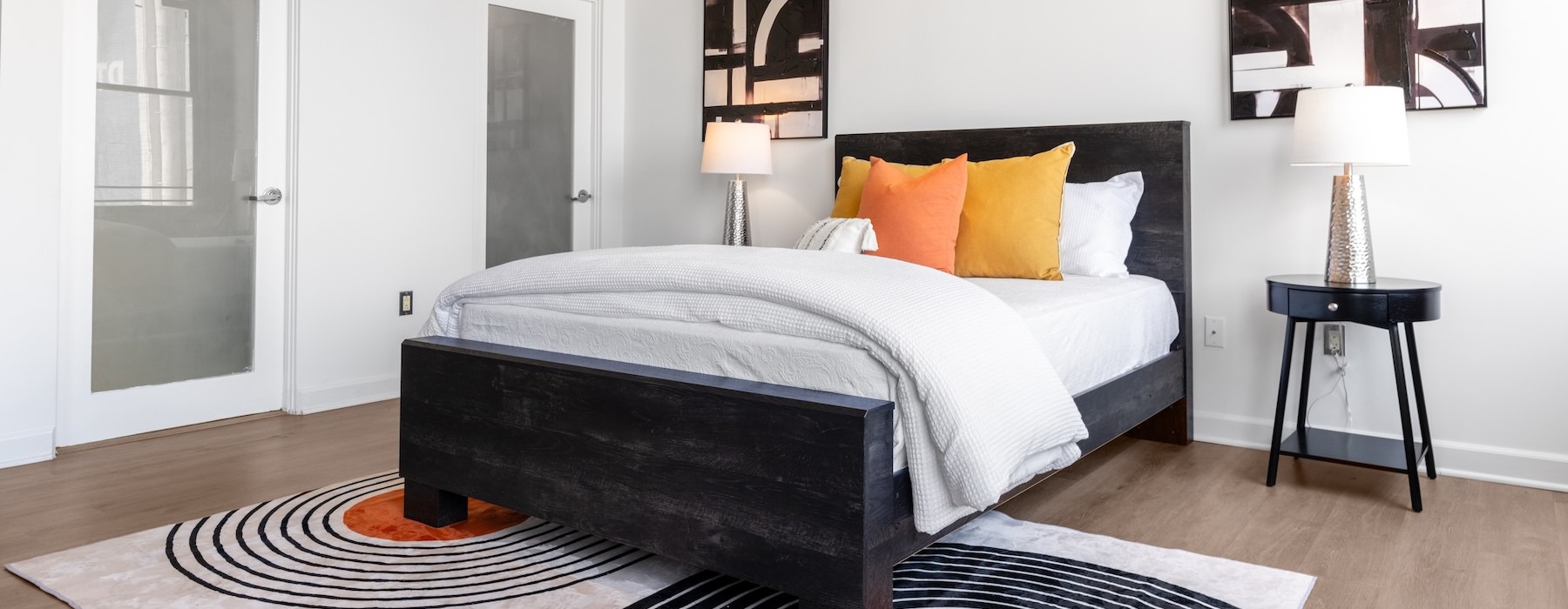 a bedroom with a bed and two nightstands