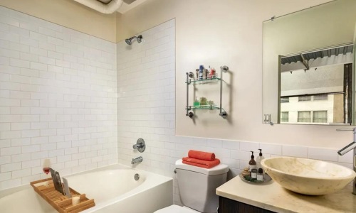 a bathroom with a tub, sink and toilet