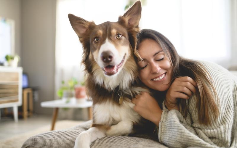 a woman hugging a dog