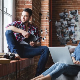 a couple relaxing and looking out a window