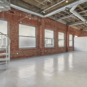 a large empty room with a staircase